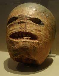 A turnip with a scary human face carved into it.