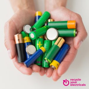 Image shows two cupped hands holding various types of batteries. Text in the bottom right of the image reads "Recycle your electricals".