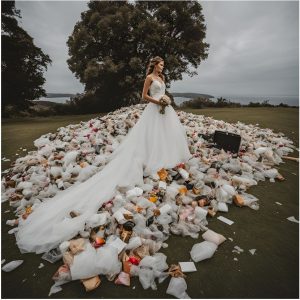 A bride in her wedding gown stood amongst a pile of waste at a wedding venue.