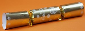 An image of a gold and white coloured Christmas cracker with 