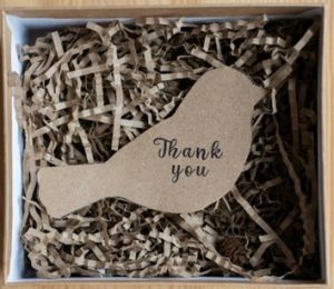 An image of a carboard box containing shredded cardboard as the packaging material