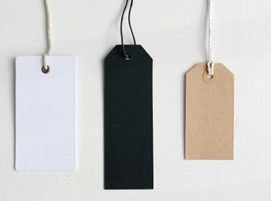 A row of three gift tags with string, white, black and brown.